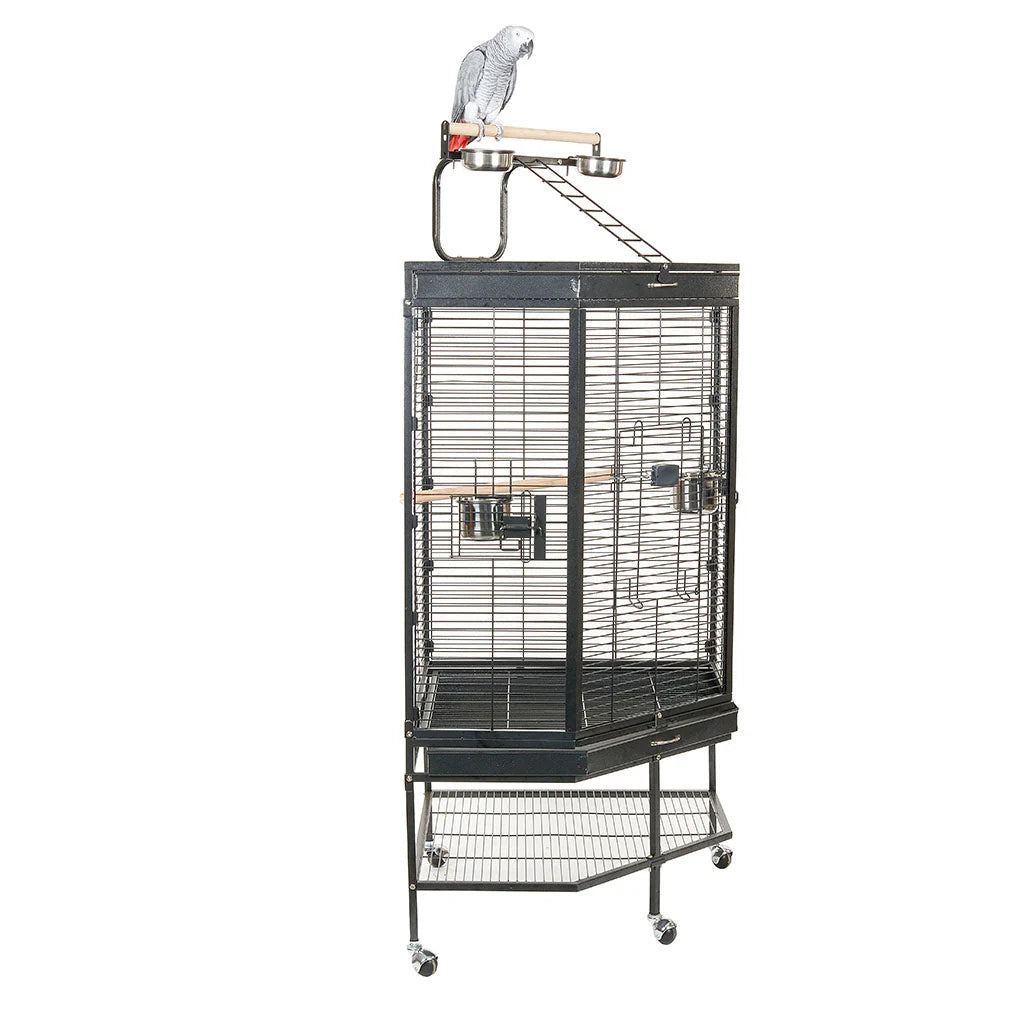 A large, charcoal-grey Liberta Alaska corner parrot cage showing swing-out stainless steel bowls, a large front lock, and an integrated seed catcher trim.