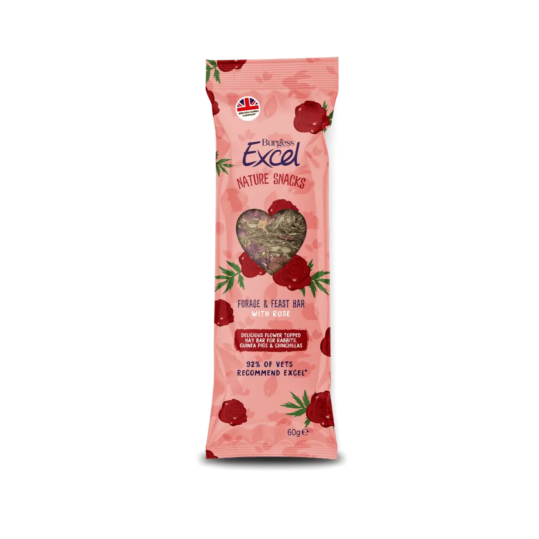 A compressed Burgess Excel meadow hay foraging bar topped with pink rose petals and dried green herbs.