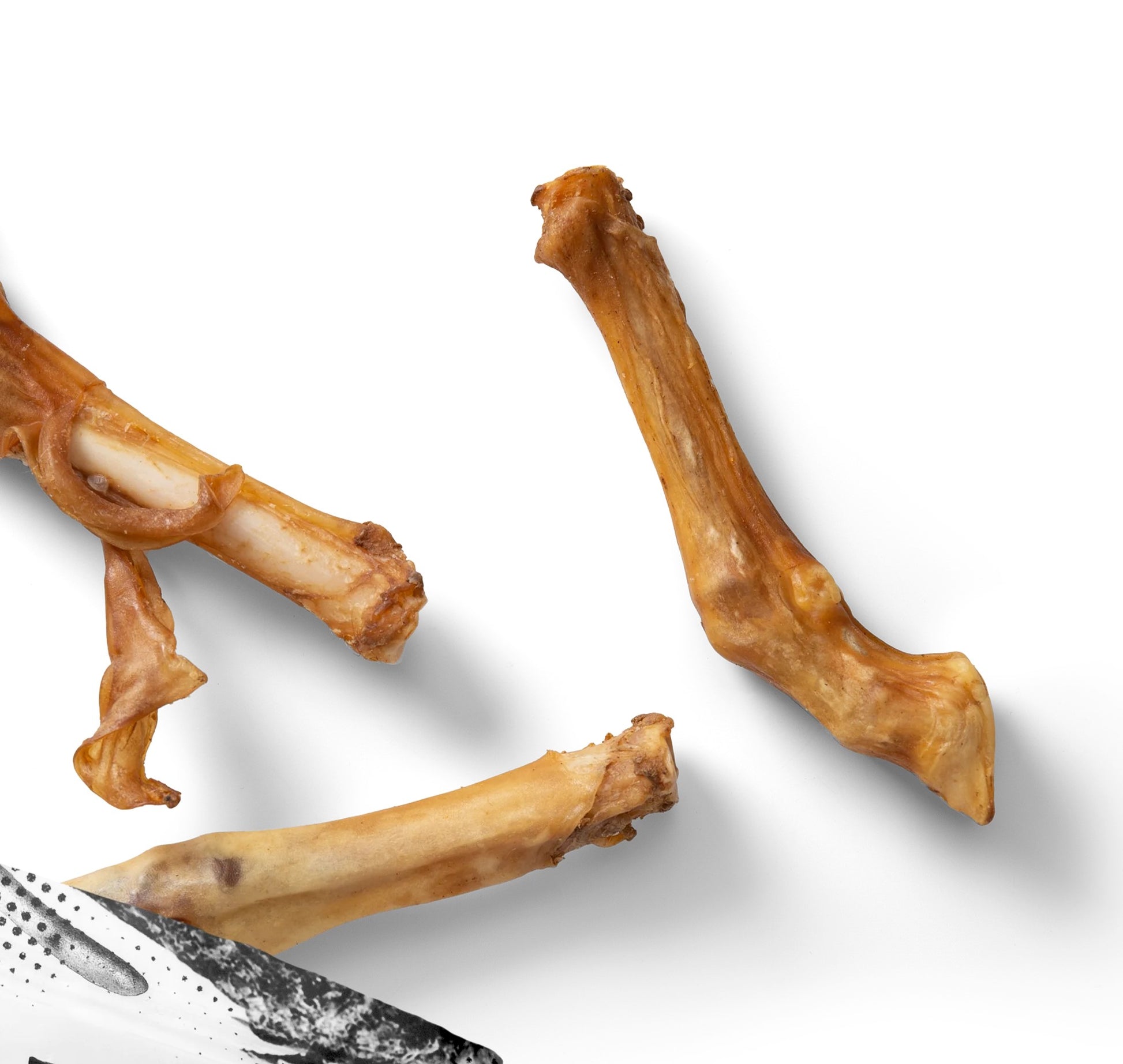 A pack of NAW! Lambs Feet dog treats, showing the air-dried natural lamb feet in clear, branded packaging.
