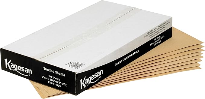 A bulk pack of rectangular Kagesan white sandsheets measuring 55x30cm, showing the rough textured sandy surface designed for bird cages.
