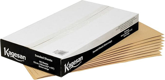 A bulk pack of rectangular Kagesan white sandsheets measuring 55x30cm, showing the rough textured sandy surface designed for bird cages.